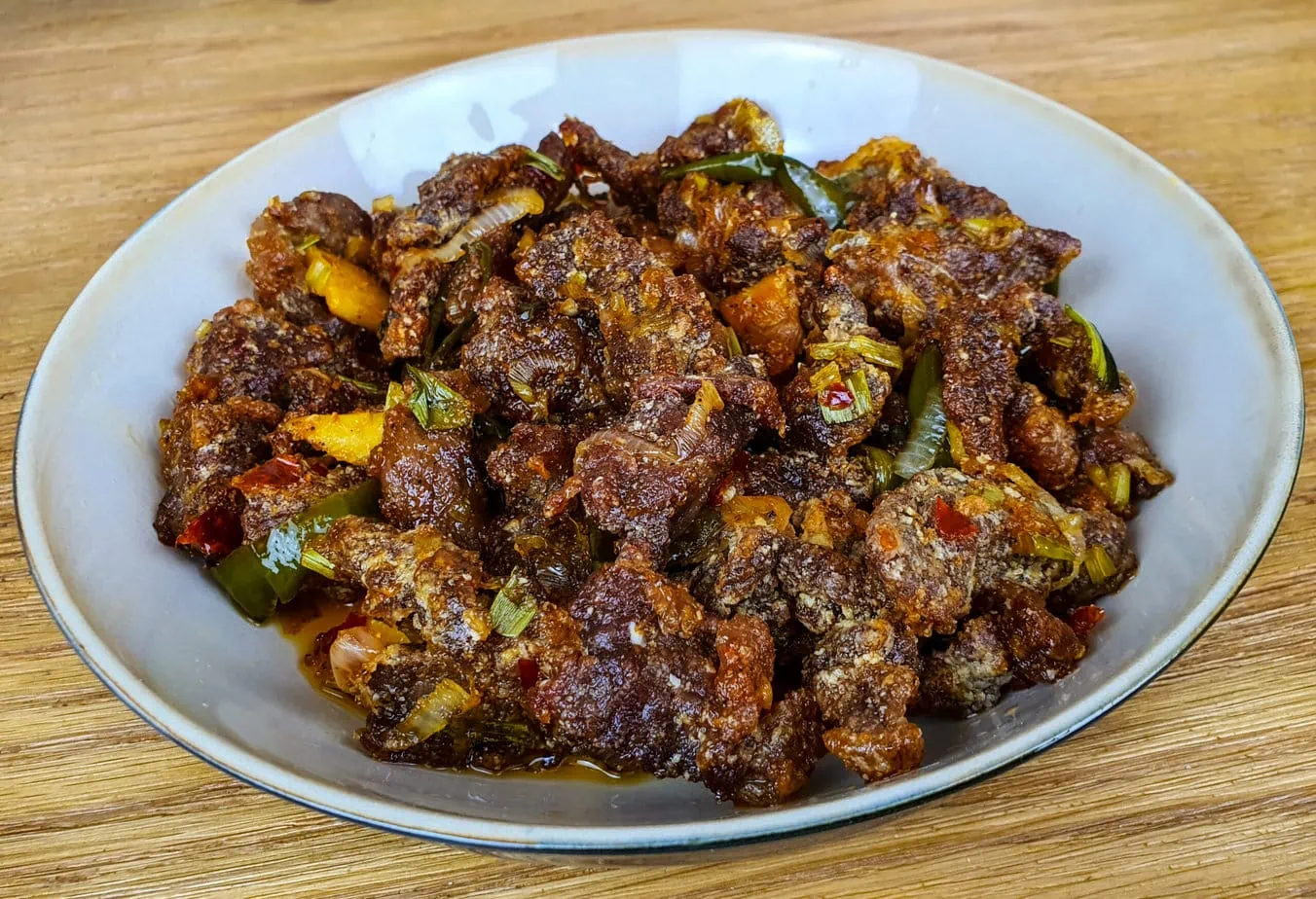 crispy chili beef on a wooden background