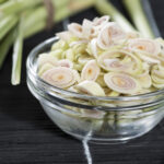 bâtonnets de citronnelle en rondelles dans une verrine sur fond noir