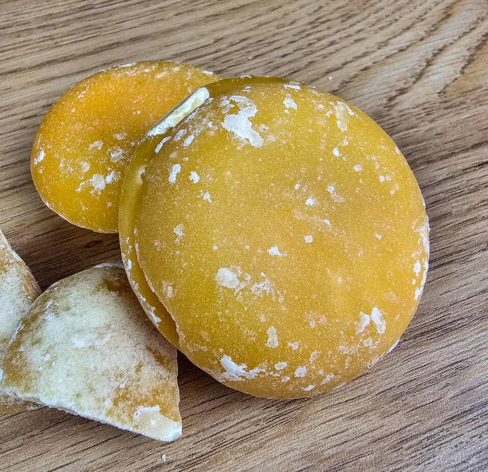 Close-up of a lump of palm sugar with wooden background