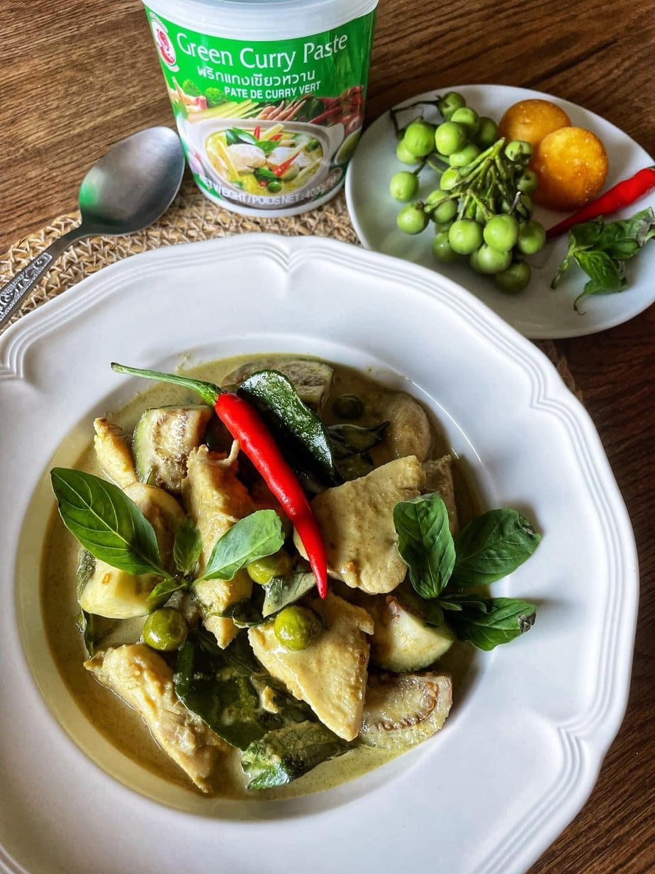 green thai curry chicken on a white plate in an enlarged layout