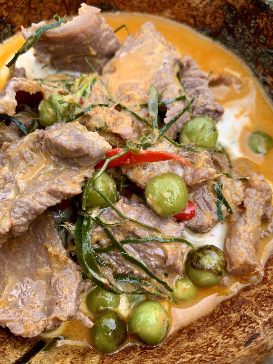 Panang beef curry in the wok with eggplants