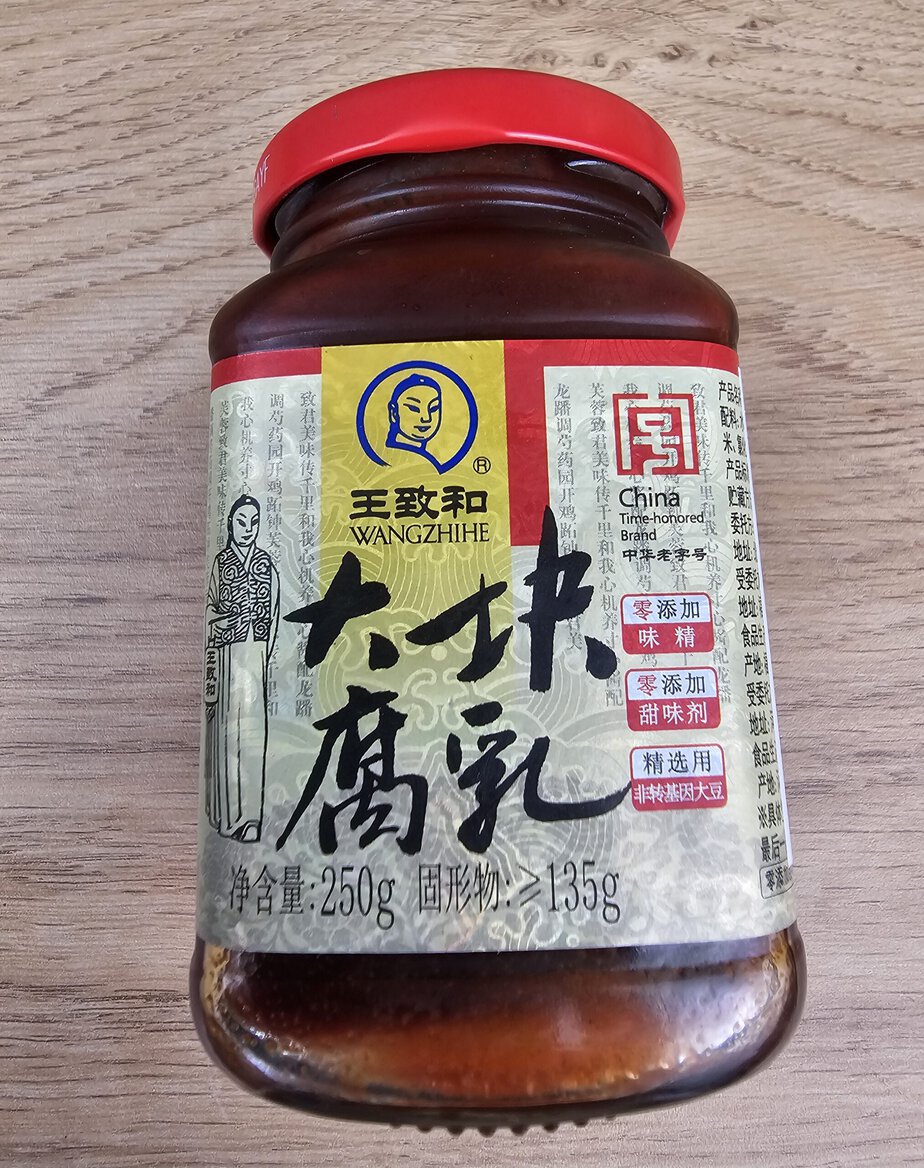 Pot de tofu fermenté rouge sur fond de bois