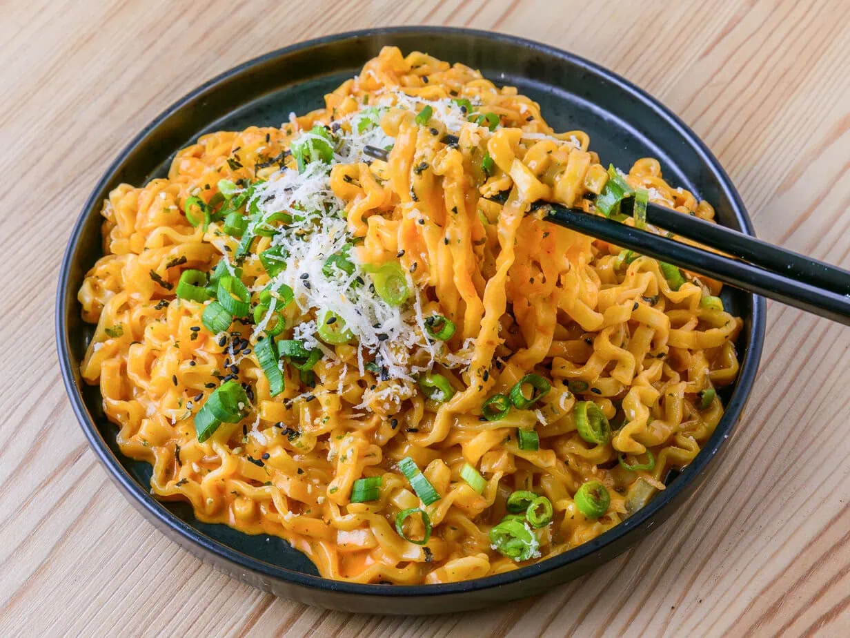 Buldak carbonara on a wooden background