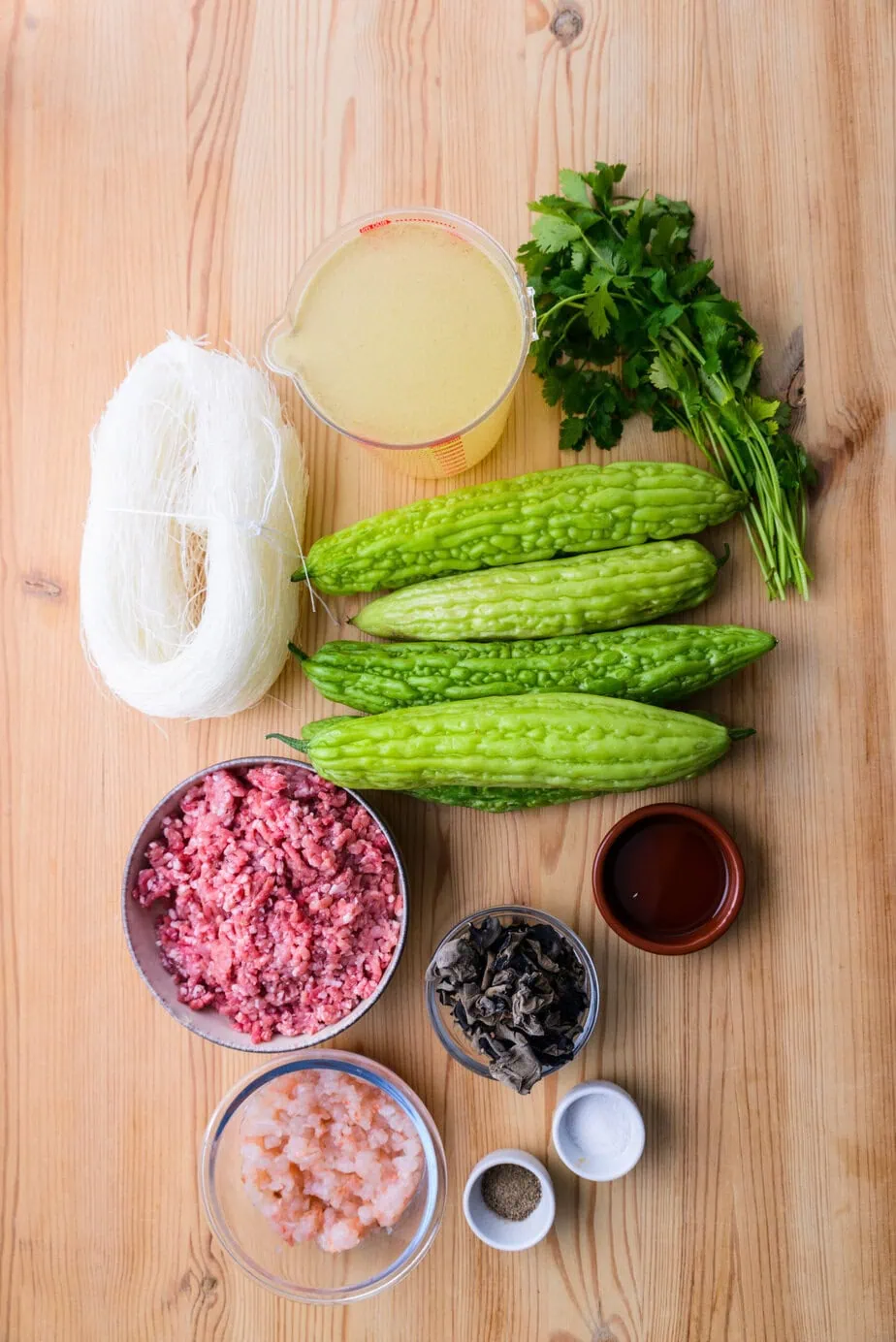 Ingredients for Bitter Melon Soup on a wooden background