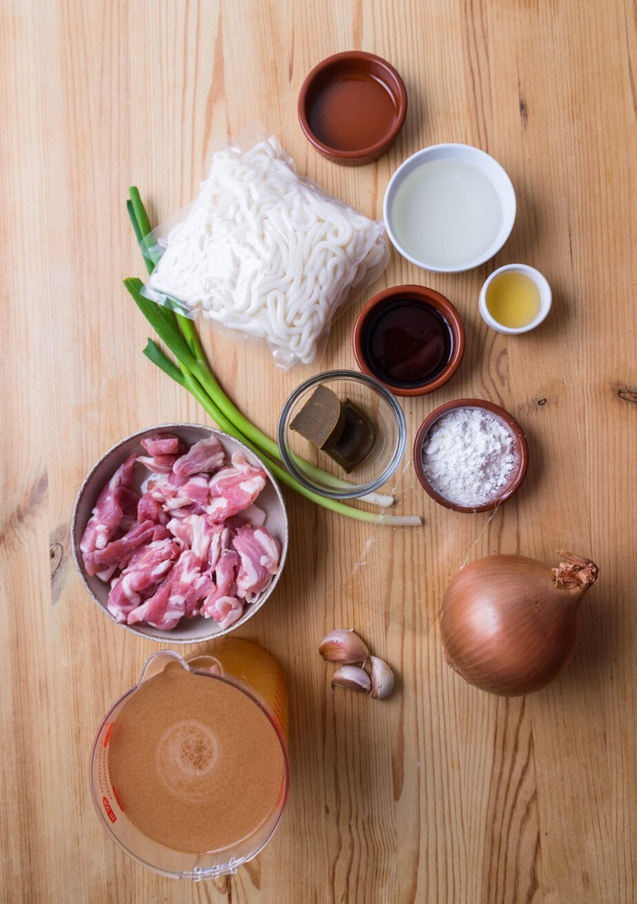 Ingredients for curry udon on a wooden background