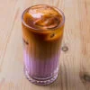 Une latte dans un verre sur fond de bois