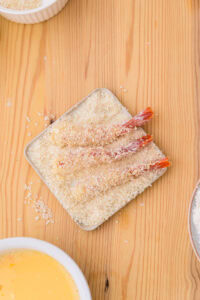 Ebi fry - Recette authentique - Paner: Poser la crevette dans la chapelure en la couchant depuis le côté tête, puis recouvrir généreusement de chapelure.