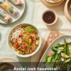 Couverture de livre de recettes asiatiques printanières avec nouilles, rouleaux de printemps et raviolis.