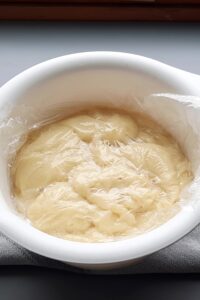 Framboisier sans gluten - Ajoute trois framboises entières au milieu, quelques gouttes de nappage neutre transparent tiédi ou de confiture de framboises, et des morceaux d’amandes effilées torréfiées.