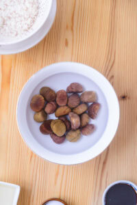 Kuri gohan (riz japonais aux châtaignes) - Les éplucher au couteau en retirant la coque dure avec la peau intérieure astringente, puis faire tremper les châtaignes épluchées dans l'eau.