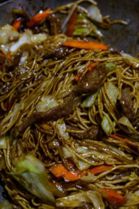 Lo mein - Mélanger délicatement les nouilles dans la sauce épaissie jusqu'à ce qu'elles soient bien enrobées, sans les casser.