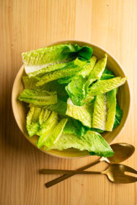 Salade César - Ajouter l'huile d'olive, le sel et le poivre.