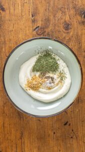 Mayonnaise, persil séché, oignon séché en flocons, sel à l'ail, sel et poivre réunis dans un bol